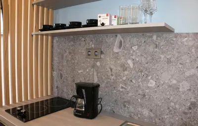 a kitchen counter with a coffee maker on a counter top at Glyfada Relax 8 in Athens