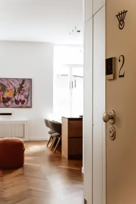 a living room with a table and a door at Likno Athens in Athens