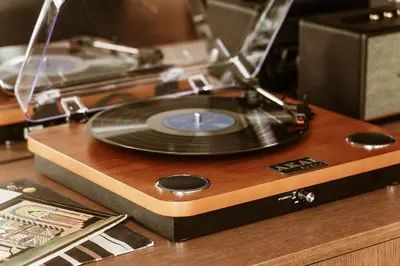 a record player sitting on top of a wooden table at Likno Athens in Athens