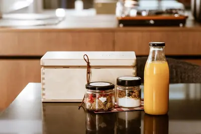 a bottle of orange juice and two jars of food at Likno Athens in Athens