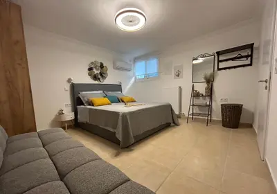 a bedroom with a bed and a couch at Meraki I in Varkiza
