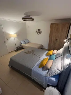 a bedroom with a bed and a couch at Meraki I in Varkiza