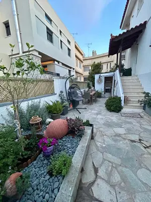 a garden with plants and flowers in front of a building at Meraki I in Varkiza