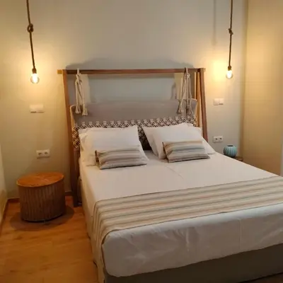 a bedroom with a large bed with two pillows at Gargaretta Suites Wildflower 2 Acropolis Museum District in Athens