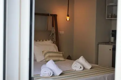 a bedroom with a bed with towels on it at Gargaretta Suites Wildflower 2 Acropolis Museum District in Athens