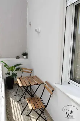 two chairs and a table in front of a window at Gargaretta Suites Wildflower 2 Acropolis Museum District in Athens