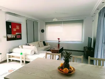 a living room with a table and a couch at Porto SkyLine in Porto Rafti