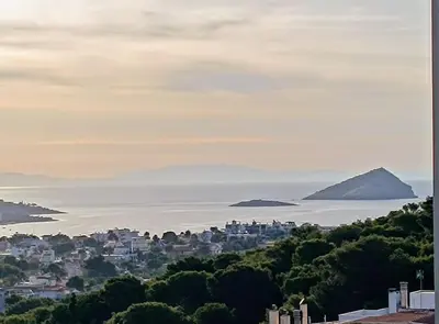 a view of a city and the ocean with mountains at Porto SkyLine in Porto Rafti