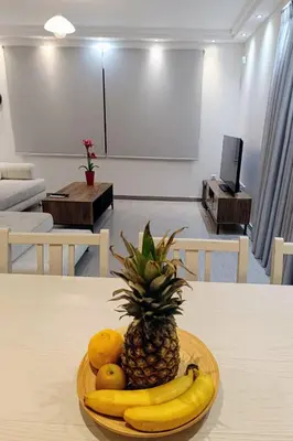a plate with a pineapple and fruit on a table at Porto SkyLine in Porto Rafti
