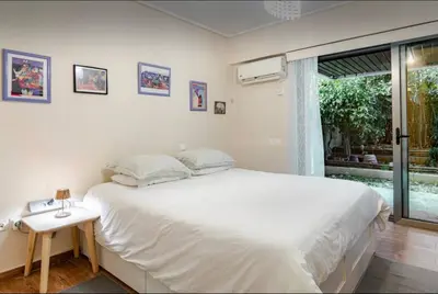 a bedroom with a large white bed and a window at Beach of Falio in Athens