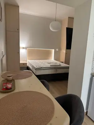 a small room with a bed and a table and chairs at Athinais Inner Suite - historical center in Athens