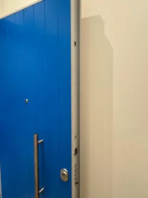 a blue door is next to a wall at Hermes Central Suite in Athens