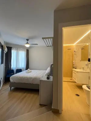 a bedroom with a bed and a bathroom with a sink at Aristeidou 10 Suite by Zeussuites in Athens