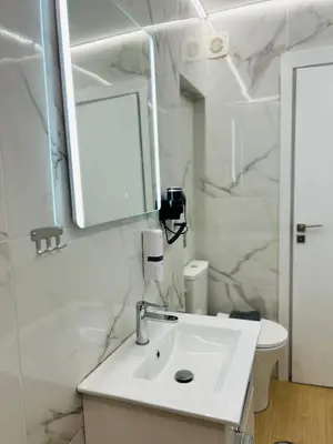 a white bathroom with a sink and a mirror at Aristeidou 10 Suite by Zeussuites in Athens