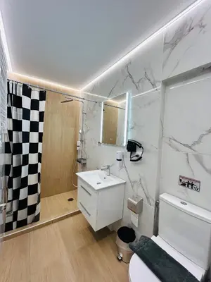 a white bathroom with a sink and a toilet at Aristeidou 10 Suite by Zeussuites in Athens