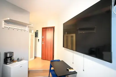 a room with a large flat screen tv on a wall at Aristeidou 10 Suite by Zeussuites in Athens