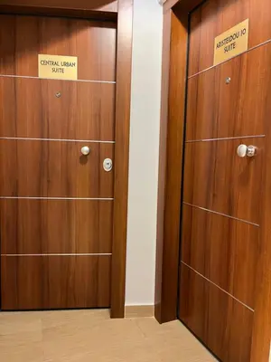 a pair of wooden doors in a room at Aristeidou 10 Suite by Zeussuites in Athens