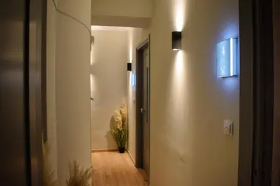 a hallway with a door and a plant on the wall at Gargaretta Suites Wildflower 3 Acropolis Museum District in Athens