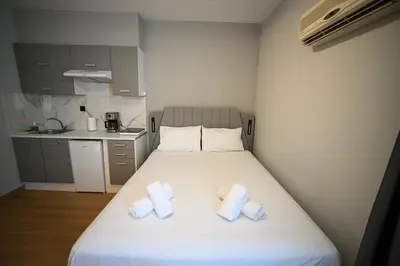 a bedroom with a bed with two towels on it at Central Urban Suite by Zeussuites in Athens