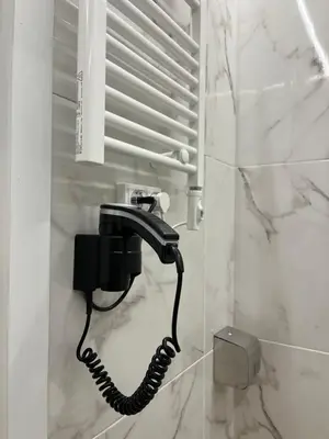 a black phone on a wall in a bathroom at Central Urban Suite by Zeussuites in Athens