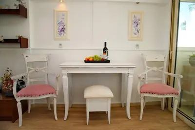 a table with two chairs and a bottle of wine at Glyfada Panoramic view penthouse in Athens