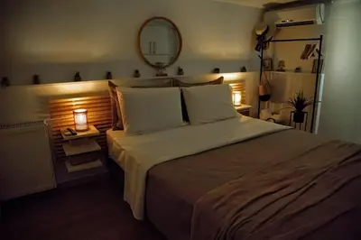 a bedroom with a large bed and a mirror at Glyfada Panoramic view penthouse in Athens