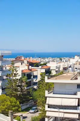 a city with buildings and the ocean in the background at Glyfada Panoramic view penthouse in Athens