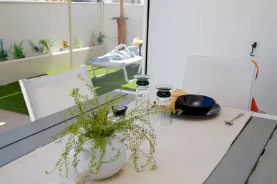 a table with a vase with a plant on it at Glyfada Panoramic view penthouse in Athens