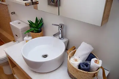a bathroom with a sink and a toilet at Glyfada Panoramic view penthouse in Athens