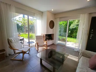 a living room with a couch and a coffee table at Garden house by the sea in Vari