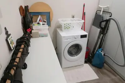a laundry room with a washer and a washing machine at Garden house by the sea in Vari