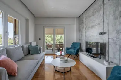 a living room with a couch and a fireplace at Voula's 2BR Escape Elegant and Stylish Living in Athens