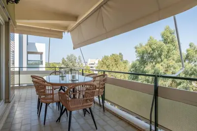 a balcony with a table and chairs on it at Voula's 2BR Escape Elegant and Stylish Living in Athens