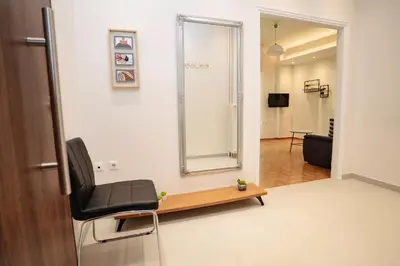 a room with a chair and a mirror on the wall at Athens downtown apartment 2bd-2ba in Athens