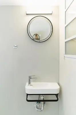 a bathroom with a sink and a mirror on the wall at Athens downtown apartment 2bd-2ba in Athens