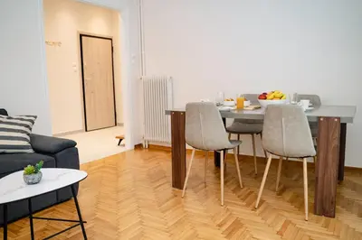 a living room with a table and chairs at Athens downtown apartment 2bd-2ba in Athens