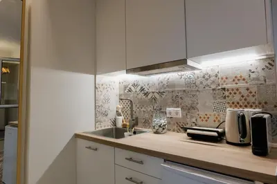 a kitchen with white cabinets and a sink at MrK Rooftop 1 in Athens