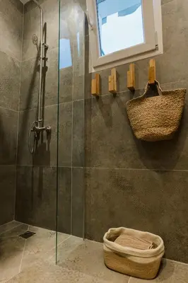 a bathroom with a shower with a window and a basket at MrK Rooftop 1 in Athens