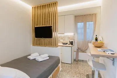 a small room with a bed and a kitchen at MrK Rooftop 1 in Athens