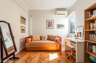 a room with a couch and a desk and a mirror at Family 2BR Apt By National Archaeological Museum in Athens
