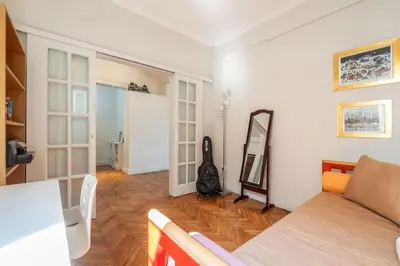 a living room with a couch and a mirror at Family 2BR Apt By National Archaeological Museum in Athens