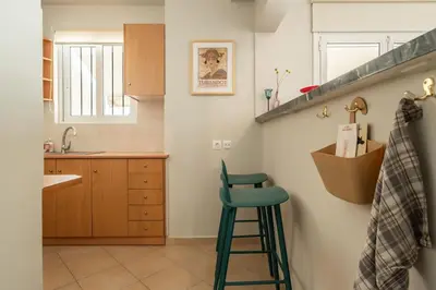 a kitchen with a green stool in a kitchen at Family 2BR Apt By National Archaeological Museum in Athens