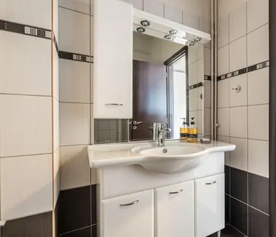 a bathroom with a white sink and a mirror at Family 2BR Apt By National Archaeological Museum in Athens