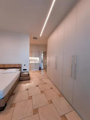 a bedroom with a bed and a tile floor at Astak in Piraeus