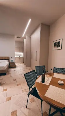 a room with a bed and a table and chairs at Astak in Piraeus