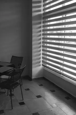 a dining room with a table and chairs and a window at Astak in Piraeus