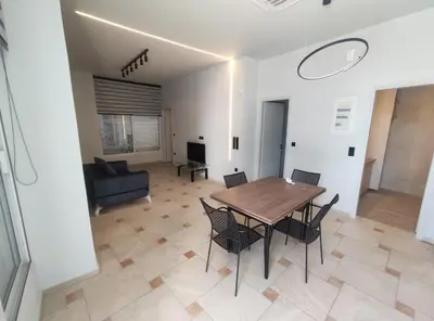 a dining room with a table and chairs and a couch at Astak 2 in Piraeus