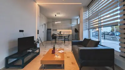 a living room with a couch and a table at Astak 2 in Piraeus