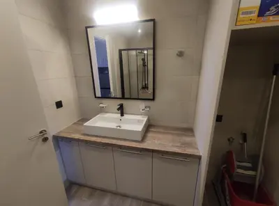 a bathroom with a white sink and a mirror at Astak 2 in Piraeus