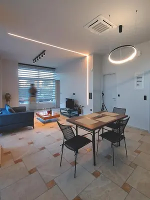 a living room with a table and chairs and a couch at Astak 2 in Piraeus